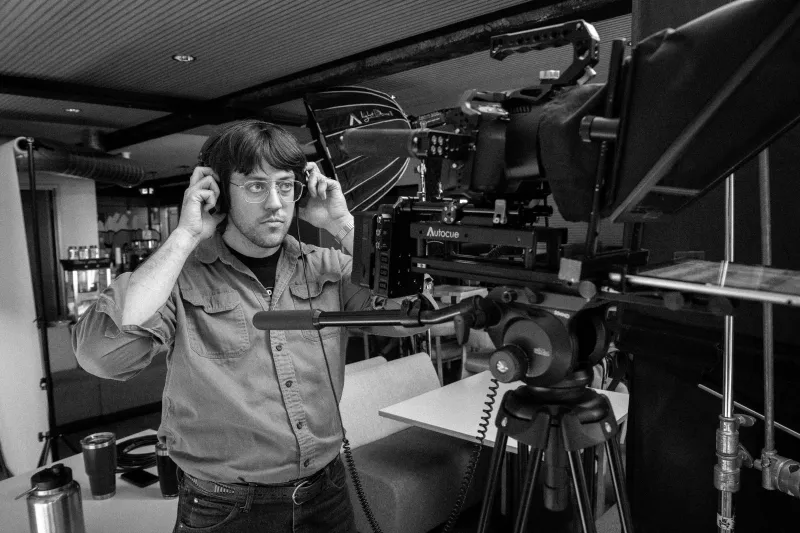 Operator framing a shot on a cinema camera rig