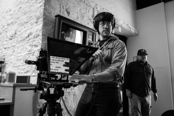 Two Clix Studios crew behind the camera with a clapperboard