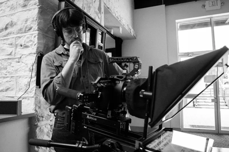 Director reviewing a shot behind the teleprompter
